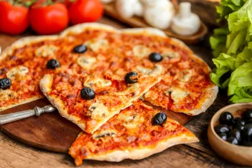 Photo d’une pizza mince garnie de sauce tomate, de fromage et de quelques olives noires.