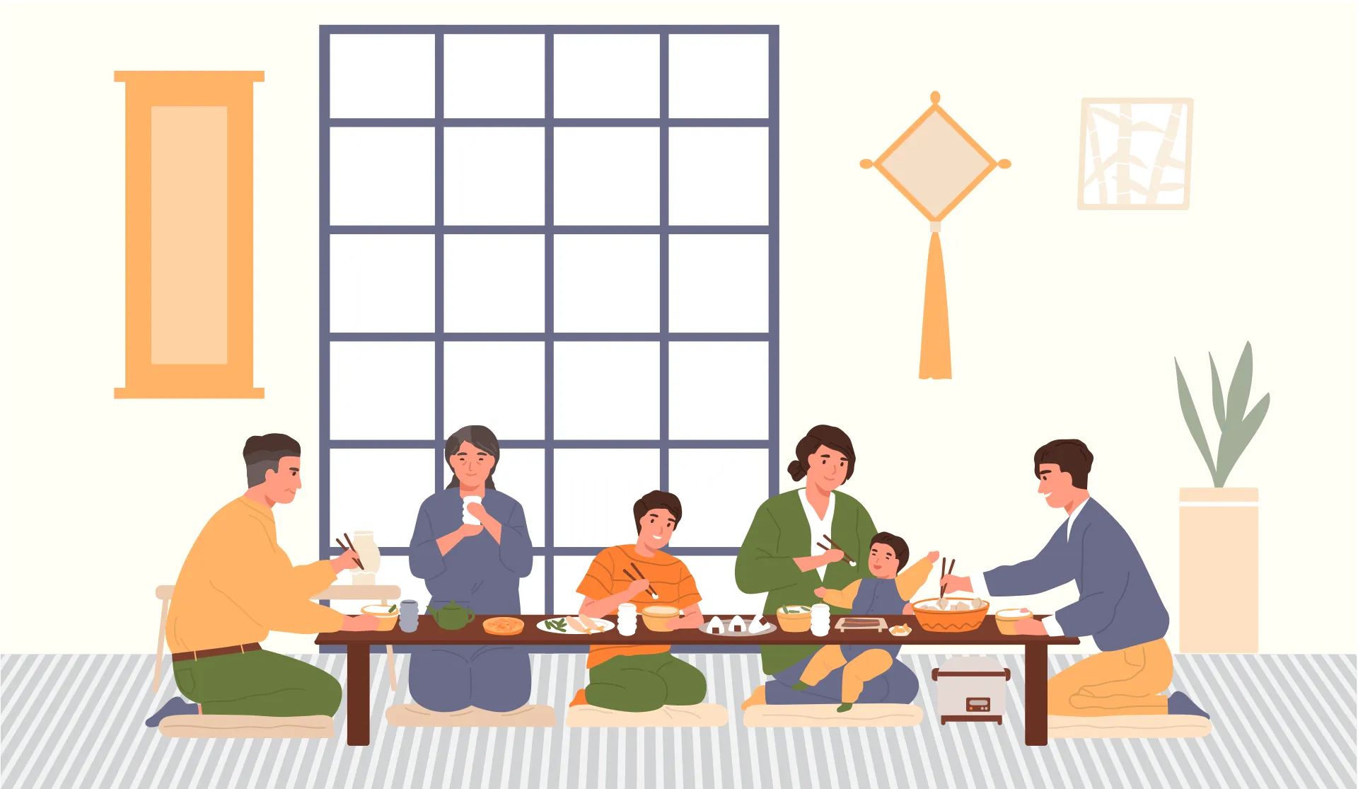 Six personnes d’âges différents assises au sol, prenant un repas à une longue table basse.